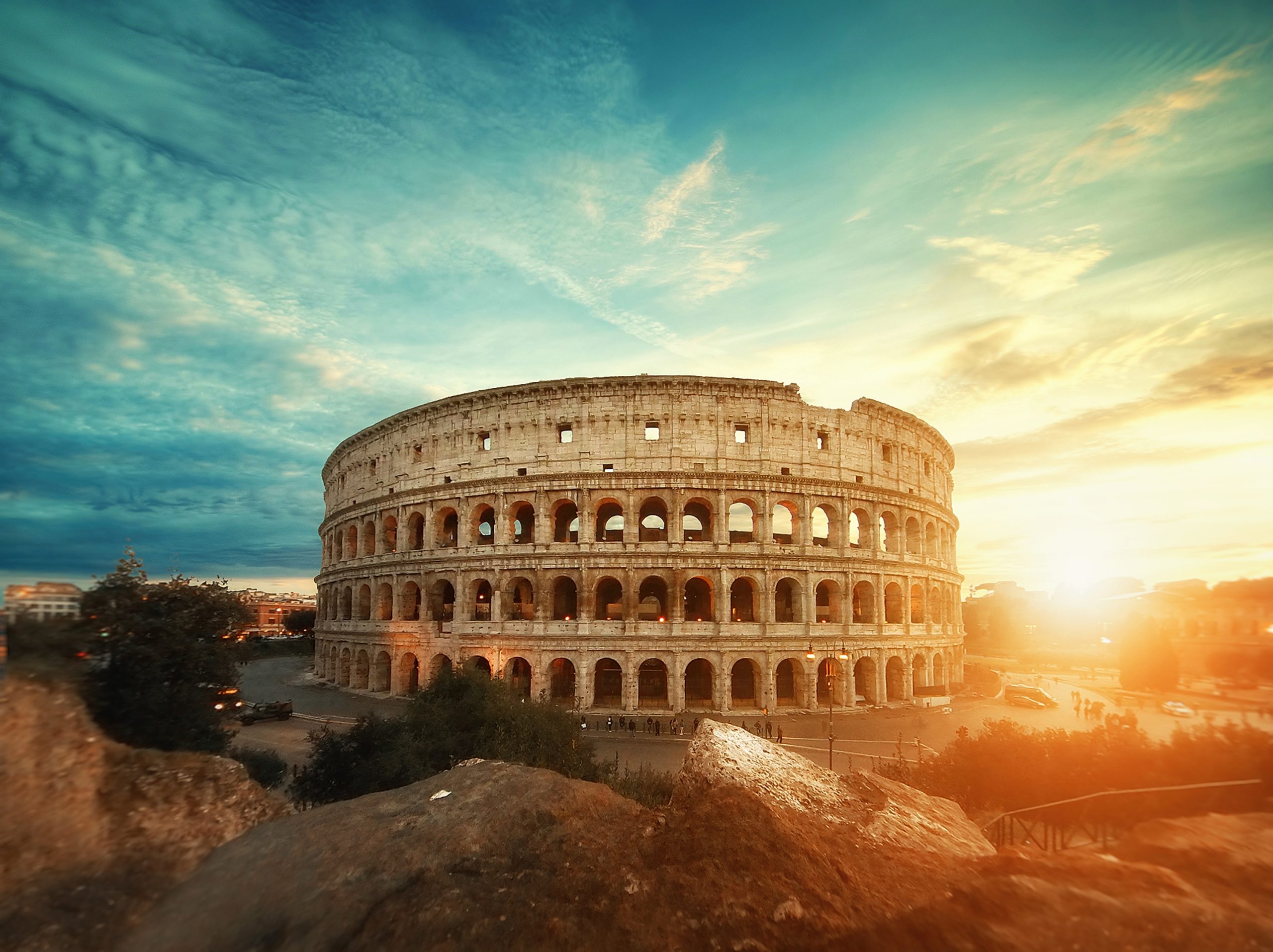 Beautiful shot of the famous Roman Colosseum amphitheater under the breathtaking sky at sunrise A beautiful shot of the famous Roman Colosseum amphitheater under the breathtaking sky at sunrise