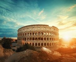 A beautiful shot of the famous Roman Colosseum amphitheater under the breathtaking sky at sunrise